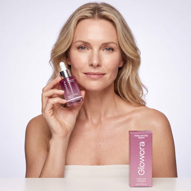 Vrouw houdt PDRN Peptide Serum flesje vast met de roze doos op tafel